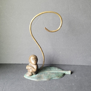 May include: A set of three ceramic mugs with a speckled, matte finish. Each mug features a different color: light blue, cream, and gray. The mugs have a simple, modern design and a comfortable handle.