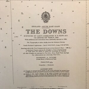May include: Antique nautical chart of the England South East Coast, titled "The Downs," surveyed in 1947. Features detailed soundings, cautionary notes, and a natural scale. Includes text and illustrations.