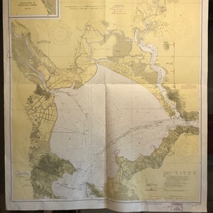 May include: A vintage nautical chart of San Pablo Bay, California, showing the coastline, islands, and waterways. The chart is printed on a cream-colored paper with brown and blue lines. The title "UNITED STATES COAST AND GEODETIC SURVEY, CALIFORNIA, SAN PABLO BAY" is printed at the top of the chart.