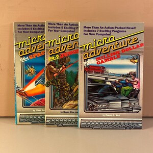 May include: Three vintage Micro Adventure game books with colorful covers. The first book is titled "Space Adventure" and features a spaceship flying through space. The second book is titled "Jungle Adventure" and features a man climbing a tree. The third book is titled "Million Dollar Gamble" and features a car driving down a street.
