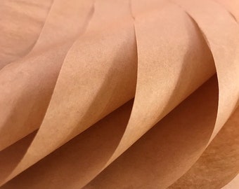 May include: Close-up of a folded sheet of brown paper. The paper is folded in a wave pattern, creating a textured surface.