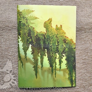 May include: Two green, furry, cat-like creatures sit on a branch covered in green ferns. The background is a soft yellow.