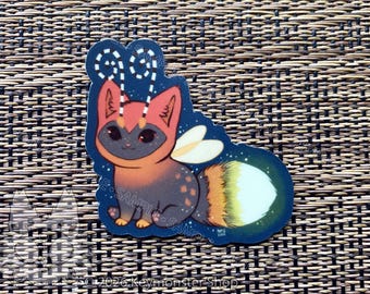 Pegatina de vinilo de un adorable gatito luciérnaga que brilla en la oscuridad.