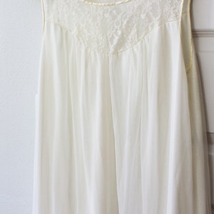 May include: A white sleeveless nightgown with a lace neckline.