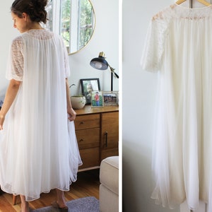 May include: A white, long, sheer nightgown with lace detailing on the sleeves and neckline. The nightgown is made of a lightweight fabric and has a flowing silhouette.