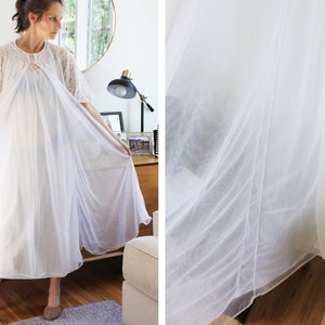 May include: A white sheer nightgown with lace detailing and a gathered neckline. The gown is flowing and has a relaxed fit.
