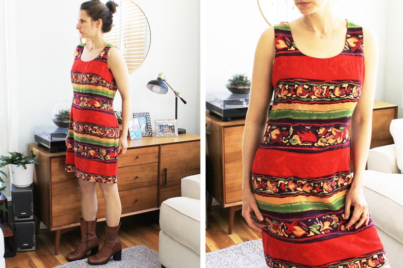 May include: A sleeveless red, green, and yellow striped dress with a floral pattern. The dress has a scoop neck and a straight hemline.