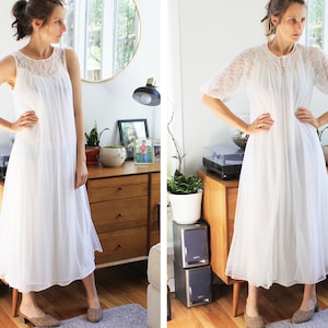 May include: A white, sleeveless, lace-trimmed nightgown with a gathered skirt. The nightgown is shown on a model in a home setting.