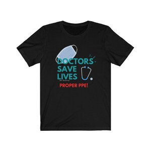 May include: Black t-shirt with a teal graphic that says "Doctors Save Lives We Deserve Proper PPE!" with a blue face mask and a stethoscope.
