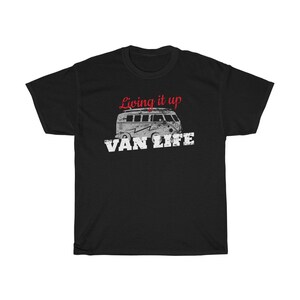 May include: Black t-shirt with a white vintage van graphic and the text "Living it up Van Life" in red.