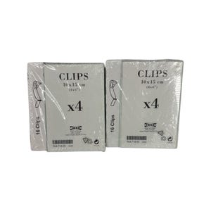May include: Two packages of IKEA photo clips, each containing four sets of clips. The packaging is white with black text that reads "CLIPS 10 x 15 cm (4x6") x4". Each package contains 16 clips.