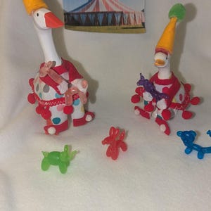 DESK GOOSE CLOWN. Size options are for the 4.5&quot;-7&quot; Desk Goose. The clown is holding a balloon animal (random). Festive outfit!