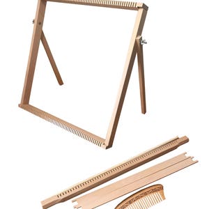 May include: A wooden loom with a stand, a comb, and a separate weaving bar. The loom is made of natural wood and has a simple design.