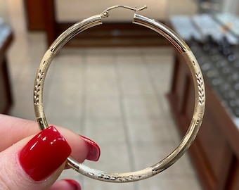 14k Real gold 2.25 Inch hoop earrings. Diamond cut with engraving design genuine gold hoops. Light Weight 3mm hoop earring.