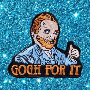 May include: Embroidered patch depicting Vincent van Gogh with orange hair and beard, giving a thumbs-up. The patch has the text "GOGH FOR IT" in orange letters on a black background. The patch is set against a sparkly, blue background.