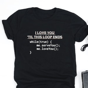 May include: Black t-shirt with the text "I LOVE YOU 'TIL THIS LOOP ENDS" in white, along with code snippets. The shirt is paired with black sneakers, folded denim jeans, and white wireless earbuds.