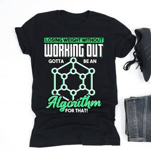 May include: Black t-shirt with the text "Losing Weight Without Working Out Gotta Be An Algorithm For That!" in white and green. The image also includes black sneakers, folded denim jeans, and wireless earbuds.
