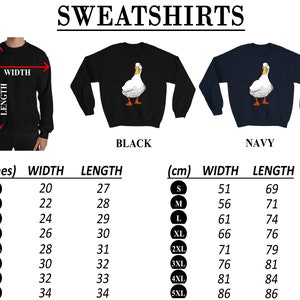 Puede incluir: Tabla de tallas para sudaderas con un gr&aacute;fico de pato blanco. La tabla muestra las medidas en pulgadas y cent&iacute;metros para las tallas S a 5XL. Las sudaderas est&aacute;n disponibles en negro y azul marino.