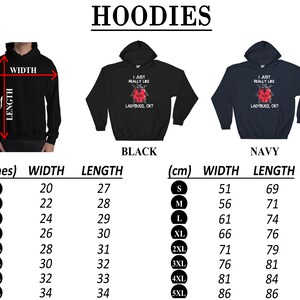 May include: A size chart for hoodies in black and navy blue. The hoodies feature a graphic of a ladybug with the text "I just really like ladybugs, ok?" The chart shows measurements in inches and centimeters for sizes S through 5XL.