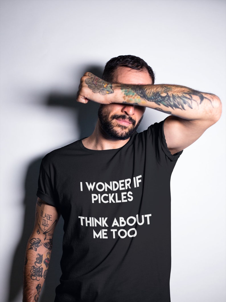 May include: A black t-shirt with white text that reads "I wonder if pickles think about me too".