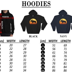 May include: Black and navy hoodies with a moose graphic inside a yellow circle, set against a sunset background. The image includes a size chart with measurements in inches and centimeters, detailing width and length for sizes S to 5XL.