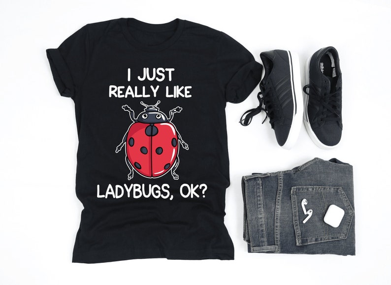 May include: Black t-shirt with white text that reads "I just really like ladybugs, ok?" and a cartoon ladybug illustration.