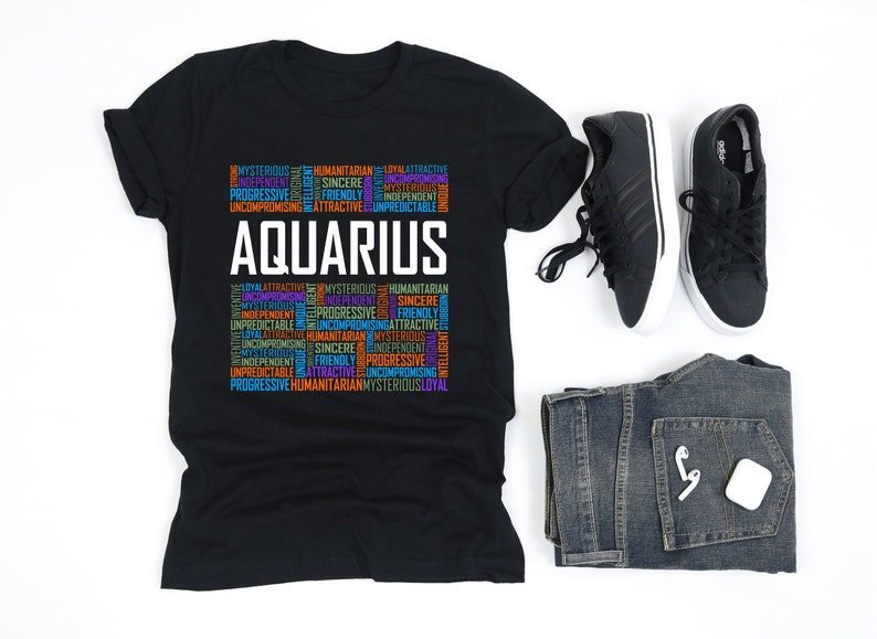May include: Black t-shirt with the word "Aquarius" in white text and a word cloud of traits associated with the zodiac sign in various colors.