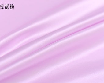 May include: A close-up of a light purple satin fabric with soft folds and a glossy sheen. The fabric is a solid color, with the number 7 and Chinese characters in the upper left corner.