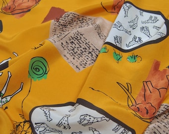 May include: Yellow fabric with a repeating pattern of giraffes, elephants, and handwritten text. The fabric has a white background with black outlines and brown and green accents. The text in the image reads "silkfabricdesigns.etsy.com".