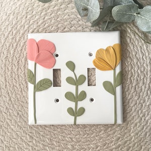 May include: A set of three ceramic vases in varying heights and shapes. The vases are glazed in a matte white finish, offering a minimalist aesthetic. The tallest vase is approximately 10 inches high.