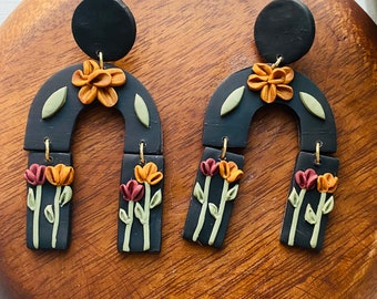 Black floral dangle clay earrings