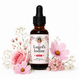May include: A brown glass dropper bottle labelled Lugol's Iodine, Natural Breast Care, Est. 2015, 20 mL, Iodine 5% w/v, and Potassium Iodide 10% w/v. The bottle is surrounded by pink roses, pink cosmos flowers, and small white baby's breath flowers.