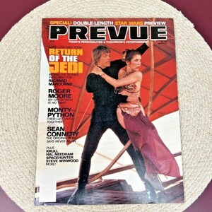 May include: A magazine cover featuring a photo of Luke Skywalker and Princess Leia from the movie "Return of the Jedi". The cover also includes text about the movie and other entertainment news.