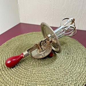 May include: A set of three ceramic vases in varying heights and shapes. The vases are glazed in a matte white finish, offering a minimalist aesthetic. The tallest vase is approximately 10 inches high.