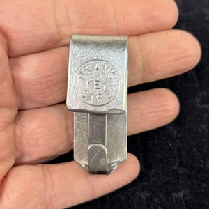 May include: A silver key safe with the words "O.A.K. KEY SAFE" embossed on the front.