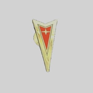 May include: A gold-colored pin with a red arrowhead shape and a white star in the center. The arrowhead is outlined in gold.