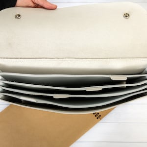 White leather accordian case for documents