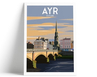 May include: A framed art print featuring a stylized illustration of Ayr, Scotland. The image showcases a bridge over a river, buildings, and a church steeple under a blue and orange sky. The word "AYR" is at the top.