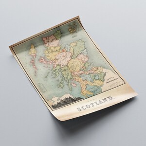May include: An antique map of Scotland, featuring detailed geographical information and various colors to distinguish regions. The map is printed on aged paper, with the word "SCOTLAND" prominently displayed at the bottom.