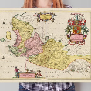 May include: An antique map of Cyclades Islands, Greece, printed in 1688. The map is in shades of yellow, pink, and green, with a coat of arms in the upper right corner. The map is titled "CYCLADES Insulae Maris EGEI."