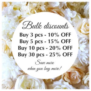 May include: A circular white sign with black text reading Bulk discounts, Buy 3 pcs - 10% OFF, Buy 5 pcs - 15% OFF, Buy 10 pcs - 20% OFF, Buy 30 pcs - 25% OFF, Save more when you buy more!, set against a background of cream and white roses.