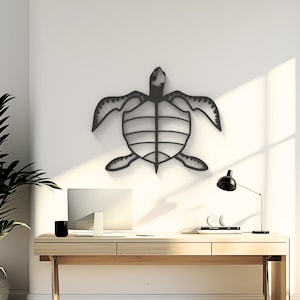 May include: Black metal turtle wall decor hanging on a white wall above a wooden desk with a laptop, lamp, and other office supplies.