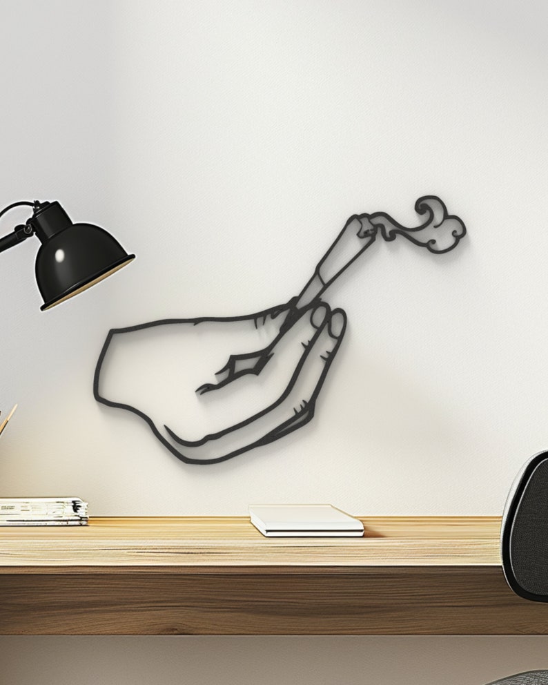May include: Black metal wall art depicting a hand holding a lit joint with smoke rising from it.