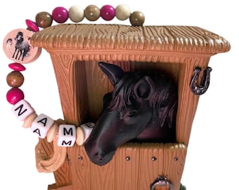 Money box horse in the stable with name, money box, piggy bank, horse black