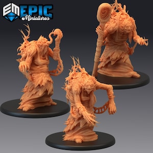 May include: Three 3D printed miniatures of grotesque, humanoid figures with decaying flesh, bone, and plant-like growths. Each figure is wearing tattered robes and has a different pose. The figures are painted in a light brown color.