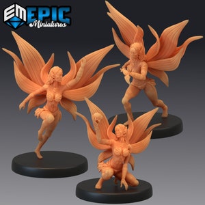 May include: Three miniature figurines of fairies with wings made of leaves. The fairies are posed in different action poses. The fairies are painted in a light brown colour.