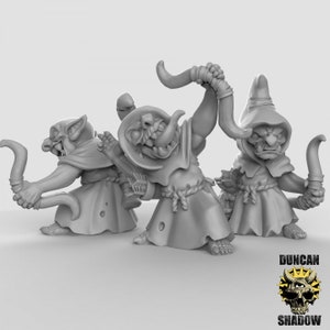 May include: Three gray goblin figurines wearing hooded robes and holding staffs. The goblins have pointed ears, large eyes, and mischievous expressions.