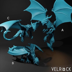 May include: Three teal dragon figurines in different poses. One dragon is mid-flight with wings spread, another is perched, and the third is crouching. The Velrock logo is visible in the bottom right corner.