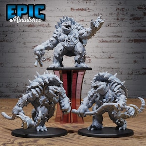May include: Three gray miniature fantasy figures. The largest figure stands on a black and red stand, holding a small figure. Two other figures are on black bases, one holding a weapon. The logo "EPIC Miniatures" is in the top left corner.