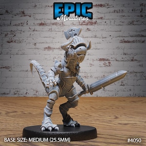 May include: A gray miniature figure of a fantasy creature in armor, holding a sword. The figure has a tail and is standing on a black base. The text "EPIC Miniatures" is at the top. The base size is medium (25.5mm).
